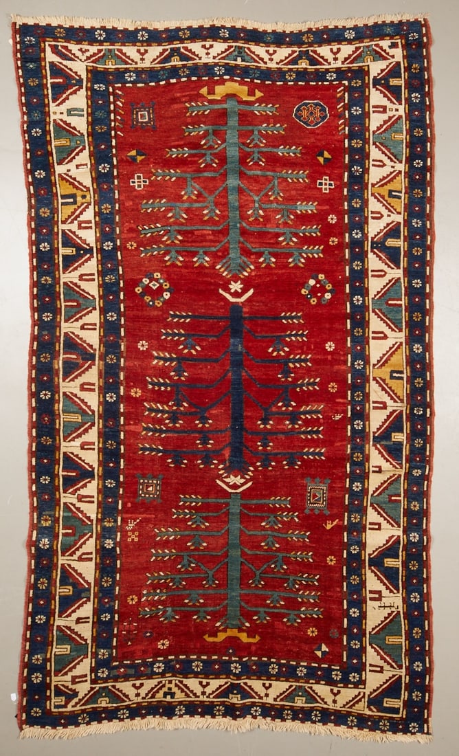 Fachralo Tree of Life Carpet: Kazak Fachralo Caucasus, circa 1900. Wool on wool. Approx. 295 x 175 cm. In the strong brick-red inner field, a monumentally executed Tree of Life motif with multi-branched branches, flanked by small