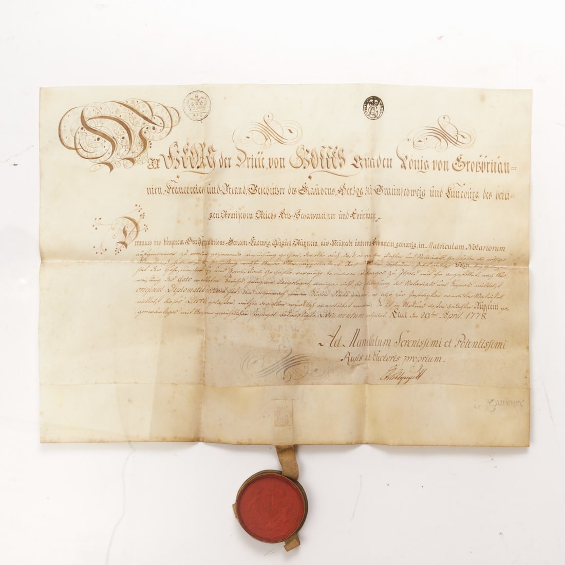 Document George III.: Document George III. (United Kingdom) Celle, 1778. Handwritten document in brown ink on pigskin with wax seal in metal capsule. 19 x 18 cm (folded size), 37 x 51 cm (overall size). Vertical and