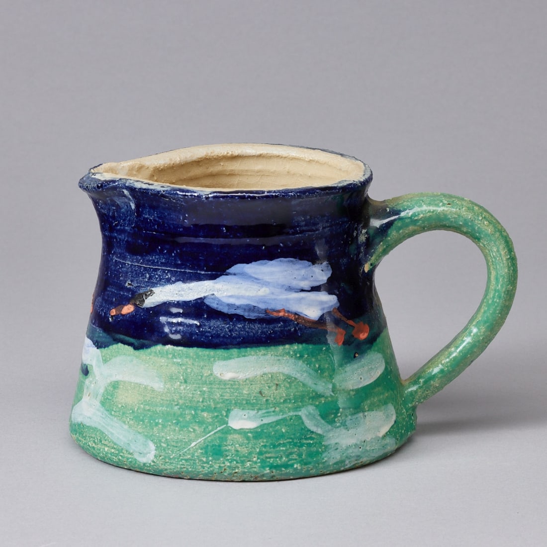 Handled jug - Swans flying. Unique piece by Klaus Fussmann, 2008.: Handled jug - Swans flying Unique piece by Klaus Fussmann, 2008. Ceramic, light shard. Surface polychromatically painted. Fired. Paper label on base: Swans, flying 11.2 cm high, 2008 Cat. 56 E