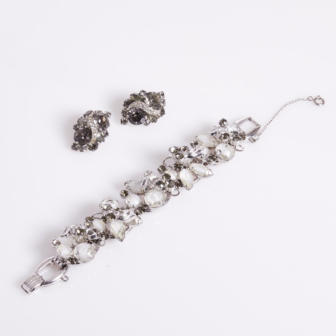 JULIANA - Vintage Bracelet with smoky rhinestones and WEISS - A pair of Vintage Ear Clips: JULIANA - Vintage Bracelet with smoky rhinestones WEISS - A pair of Vintage Ear Clips Juliana (DeLizza & Elster) New York, approx. 1960s; Albert Weiss, New York, USA, circa 1950 - 1980. Metal, silver