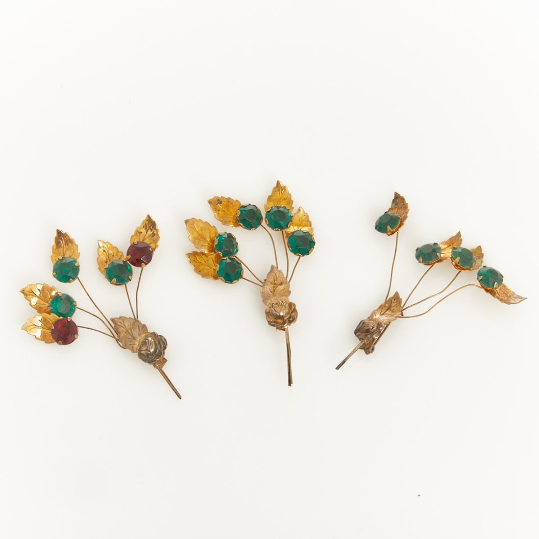 Three Vintage Designer Sterling Brooches: Three Vintage Designer Sterling Brooches Probably USA, 1940s. Sterling silver, gold-plated. Rhinestones. Total weight: 30 g. L. approx. 9.5 cm. W. approx. 8 cm. Pins have safety clasps. All hallmarked