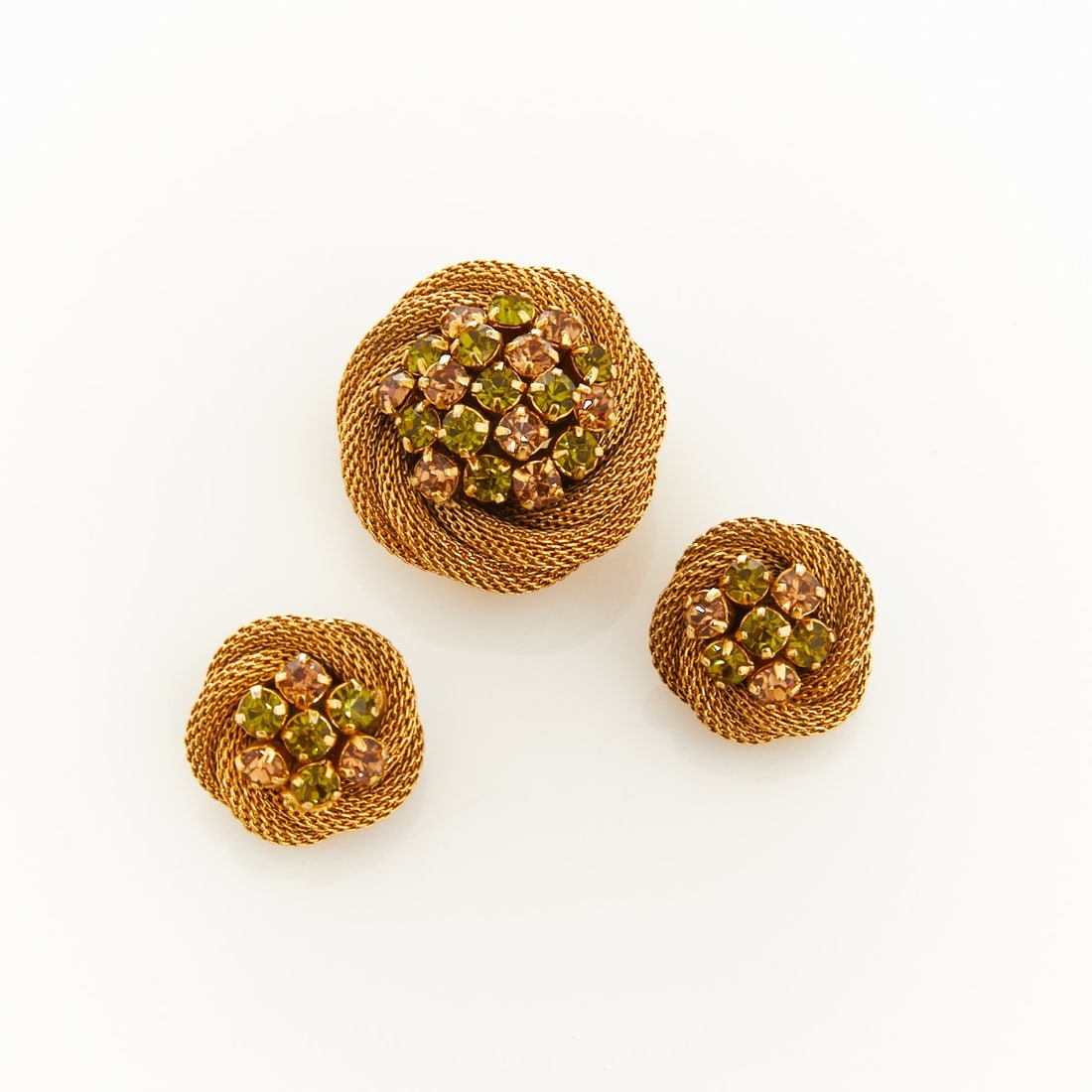 AUSTRIA - Vintage Brooch and Pair of Ear Clips: AUSTRIA - Vintage Brooch and Pair of Ear Clips Austria, circa 1940 - 1950. Metal, gold-colored; rhinestones. Weight: 22 g. Dimensions: Brooch D. 3 cm., pin with safety clasp. Ear clip D.: 2 cm. Excell