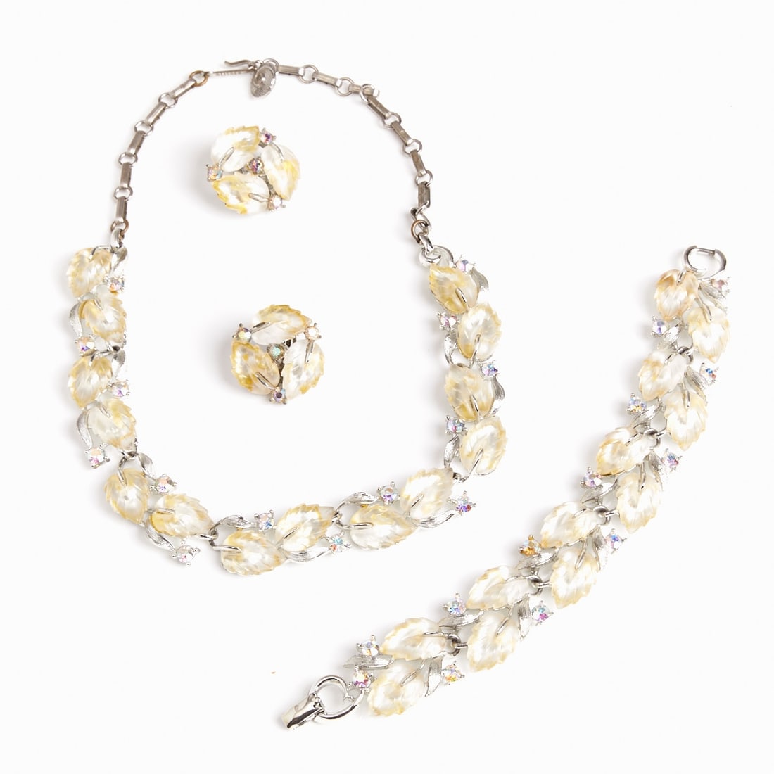 LISNER - Vintage Parure with Leaf Motif (3 parts): LISNER - Vintage Parure with Leaf Motif (3 parts) Necklace, bracelet, and pair of ear clips. Lisner, New York, circa 1950. Metal, silver-colored. Lucite and Aurora Borealis-colored rhinestones. Total