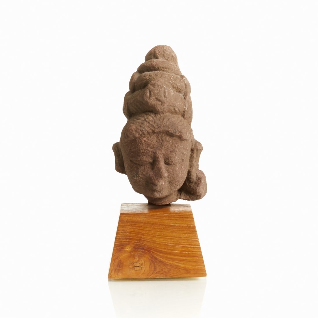 Rare pink sandstone head of Parvati from the Chandella period: Rare pink sandstone head of Parvati from the Chandella period India, probably 10th-12th century. Sandstone, mounted on a wooden base. Dimensions without base: 10 × 6 × 6.5 cm. Condition: A
