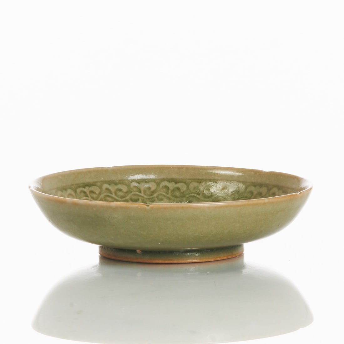 Celadon Plate with Engraved 'Lotus' in Longquan Style: Celadon plate with engraved 'Lotus' in Longquan style China, probably 20th century. Ceramic with celadon glaze. H. 4.8 cm, D. 18.5 cm. Beautiful celadon glaze with a slightly petal-shaped curved rim. 
