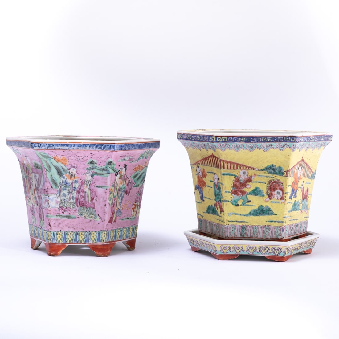 Pair of hexagonal cachepots: A pair of hexagonal cachepots China, circa 1900. Porcelain, polychrome painted. Hexagonal shape, H. 21 cm. One with a saucer. One with a palace life motif on a pink background, the other with a playin