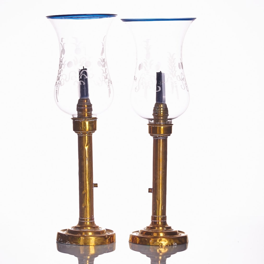 Pair of hurricane lamps in Neoclassical style: Pair of hurricane lamps in Neoclassical style France, 20th century. Brass-colored metal bases with cylindrical shafts and dome-shaped stands. Mounted tulip-shaped glass cylinders with matte ground