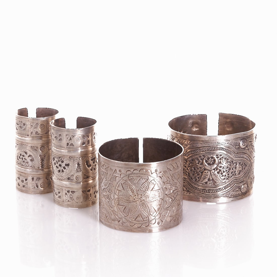 Four ethnological arm or leg bands: Four ethnological arm or leg bands Oriental / Ottoman cultural sphere, 19th/20th century. Probably silver, partly hallmarked, with rich floral, geometric and openwork ornamentation in traditional