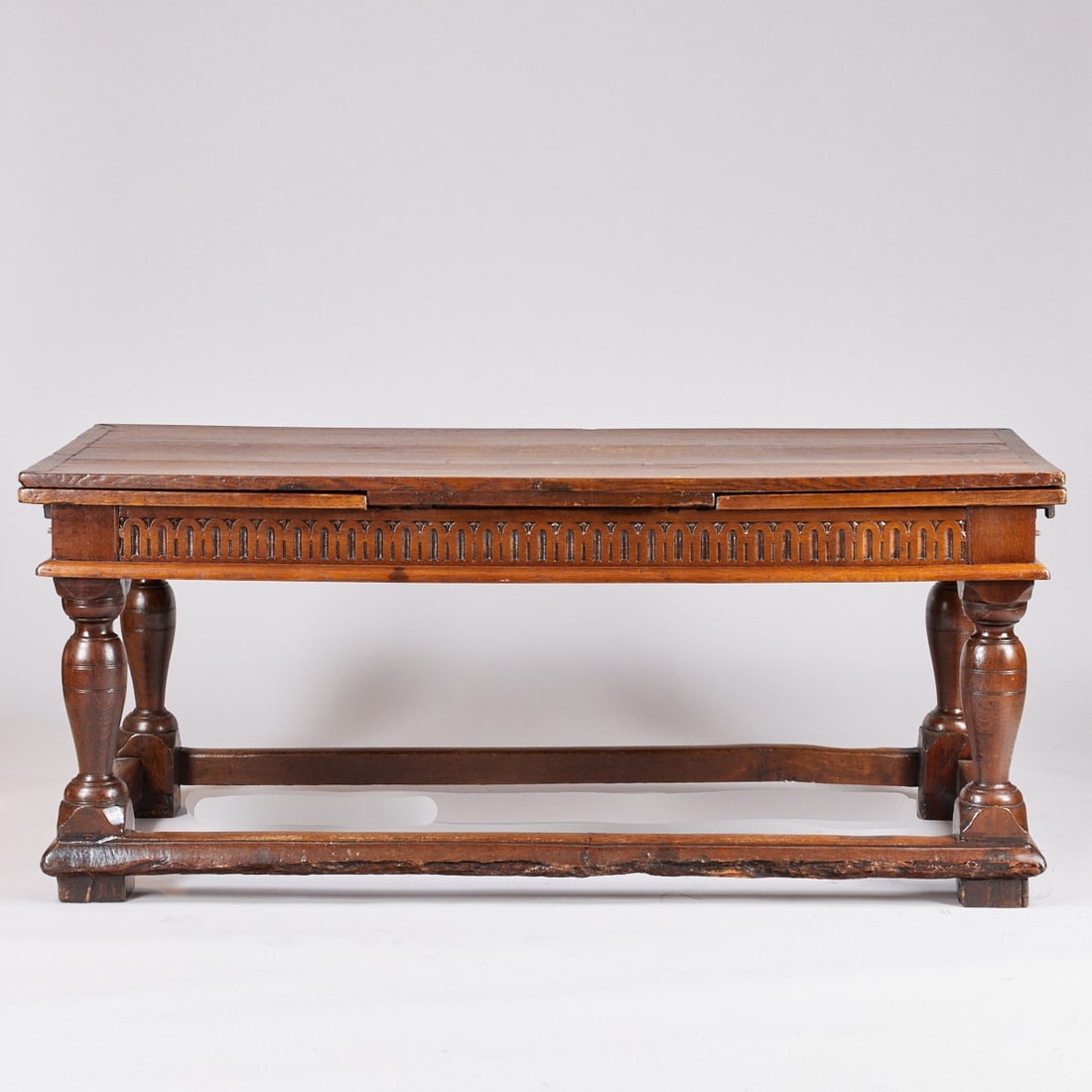 Rare Large Refectory Table with two Extendable Leaves: Rare Large Refectory Table with two Extendable Leaves France, 17th/18th C. Oak. 78 x 180/302 x 82 cm. Restored. On four braced block feet with baluster column. Strict, rectangular body with carved