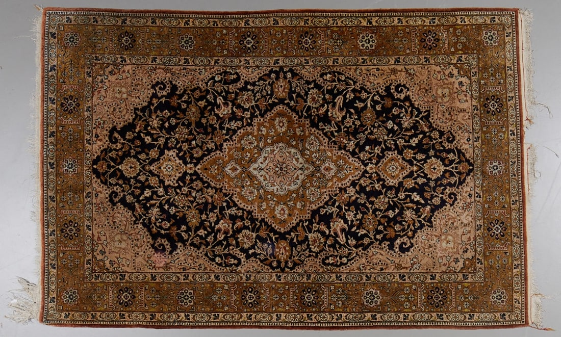 Silk Carpet: Silk carpet Persia / Orient, 20th century. Silk on silk, 218 cm x 142 cm. Dark blue central field with golden medallion and accents. Fringes partly damaged, traces of age and use.