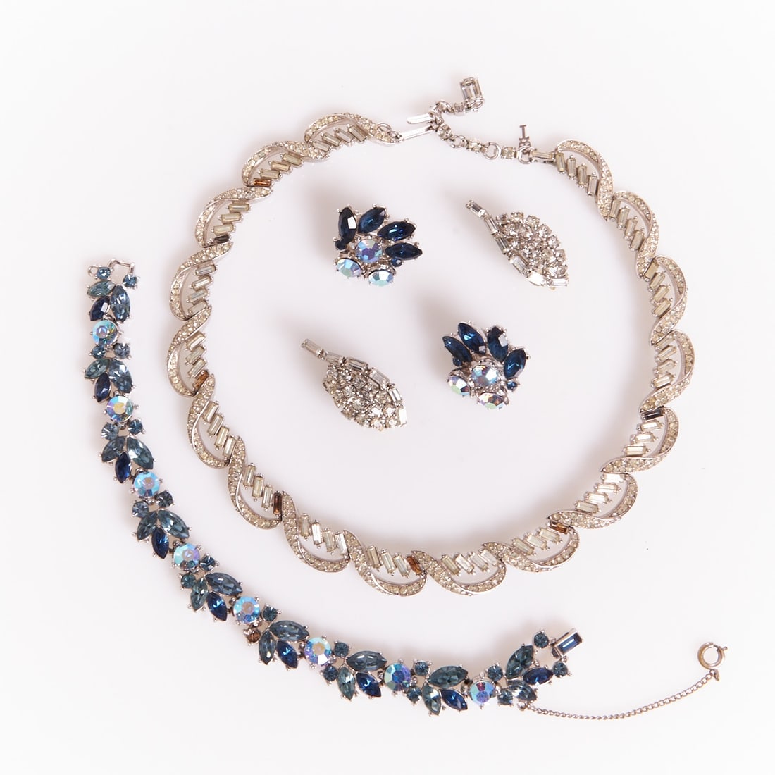 TRIFARI Alfred Philippe - Two Vintage Rhinestone Parures (4 pieces): TRIFARI Alfred Philippe - Two Vintage Rhinestone Parures (4 pieces) Necklace, bracelet and 2 pairs of ear clips. Crown Trifari, New York, circa 1950. Metal, silver-colored; crystal rhinestones; faux r