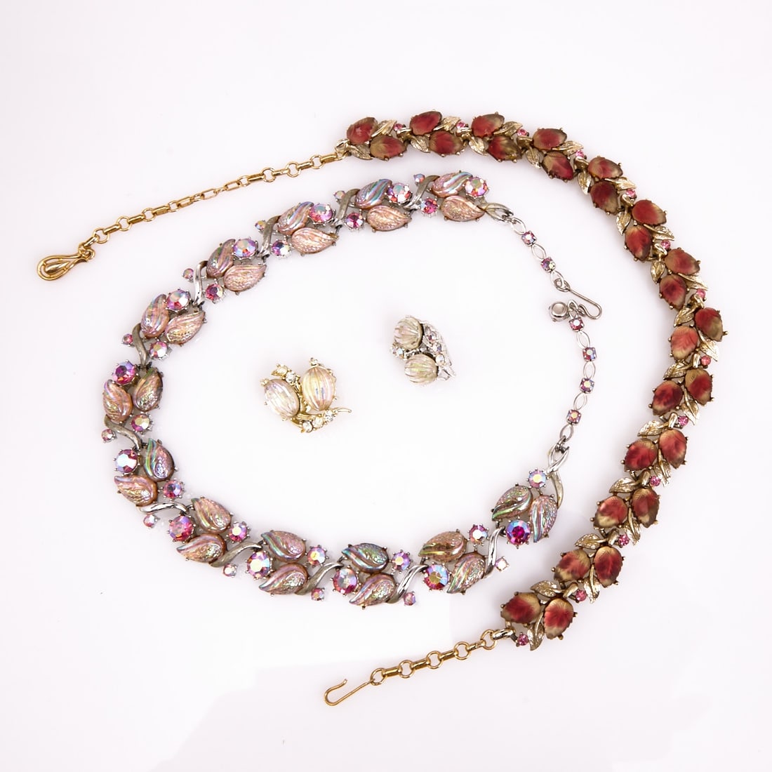 CORO - Two vintage necklaces with a pair of clip-on earrings (3 pieces): CORO - Two vintage necklaces with a pair of clip-on earrings (3 pieces) Coro Jewelry, Cohn & Rosenberger, Inc. New York, USA. 1950s - 1960s. Metal, silver- and gold-colored; Lucite; glass; rhinest