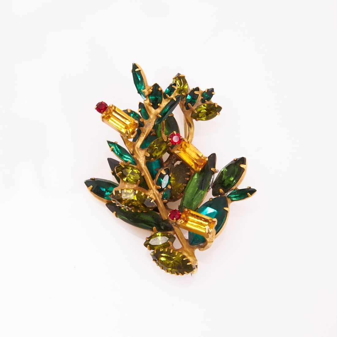 David Mandel - ''The Show Must Go On'' Vintage Brooch in the Shape of a Branch: David Mandel - ''The Show Must Go On'' Vintage Brooch in the Shape of a Branch Design: David Mandel, USA, circa 1990s. Metal, gold-colored; rhinestones in ruby and emerald green. Weight: 27 g. Dimensi