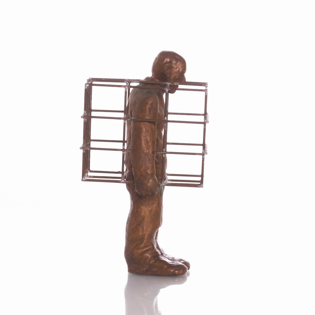 Siegfried Neuenhausen: Siegfried Neuenhausen 1931 Dormagen - lives and works in Hanover - Man in Cage - Bronze. Gold-brown patinated. 14/100. H. 16.5 cm. Monogrammed on the reverse: nh. Foundry mark: GUSS WITTKAMP