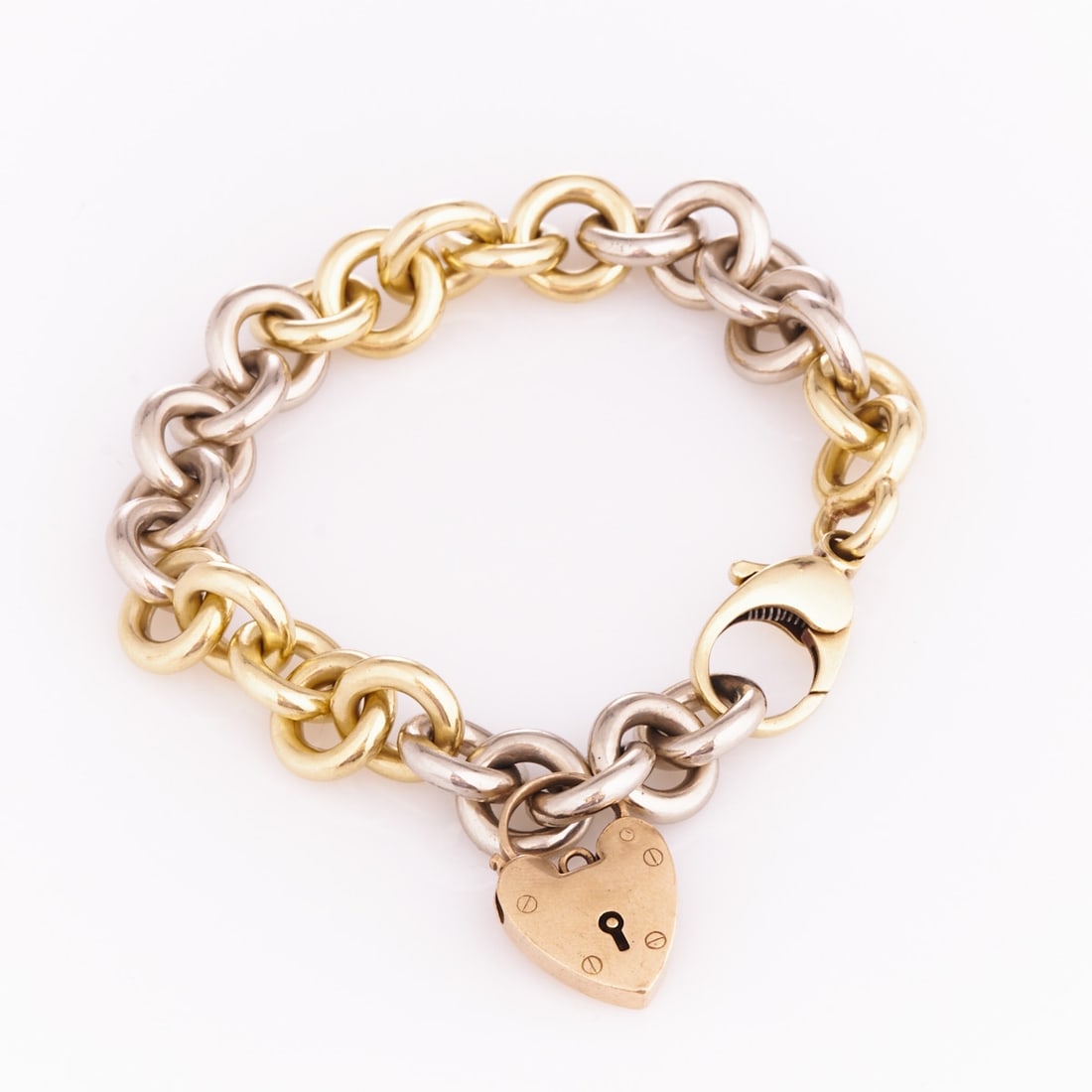Modern Gold Bracelet in Round Link Shape: Modern Gold Bracelet in Round Link Shape Goldsmith cARAt: Bernhard von Sternburg, Hanover. Solid handmade. 585/- yellow gold and white gold, stamped. Total weight: 77.2 g. Heart: 375/- rose gold, stam