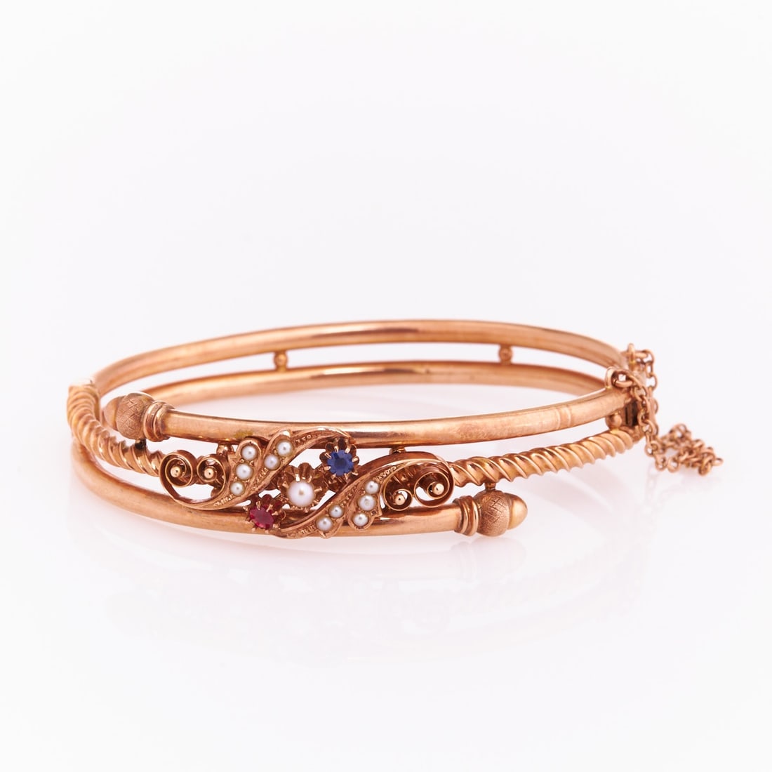 Antique bracelet with pearls: Antique bracelet with pearls. Circa 1890. 585/- rose gold, stamped. Total weight: 14 g (filled?). 11 small seed pearls. Probably sapphire and probably ruby. Box clasp. Slight signs of wear. Very