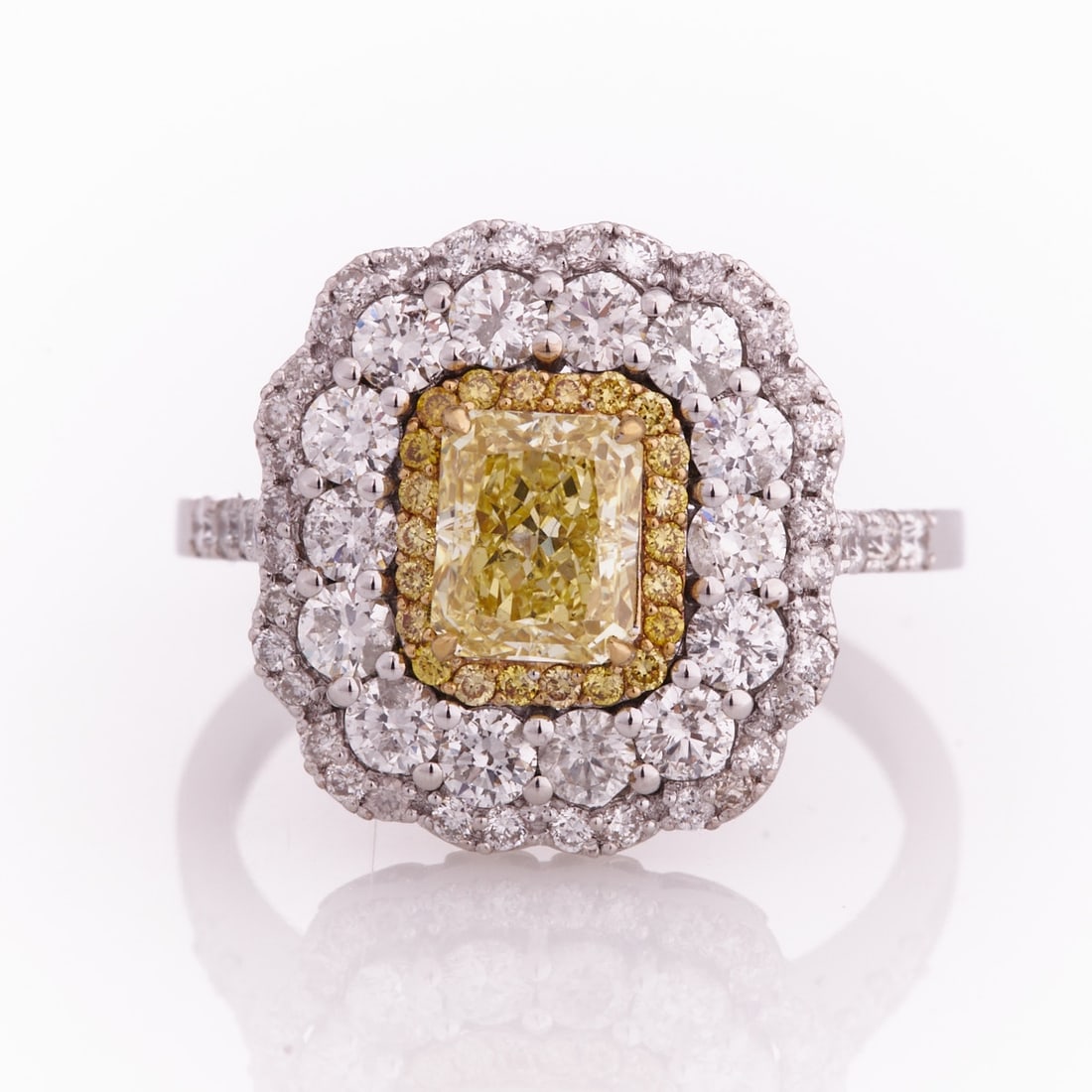 Fancy Yellow Diamond Ring with Wavy Edge: Fancy Yellow Diamond Ring with Wavy Edge 750/- white gold, stamped. Total weight: 5.8 g. 1 Fancy Diamond approx. 1.03 ct (Natural Fancy Intense Yellow/SI2). Various small yellow brilliant-cut