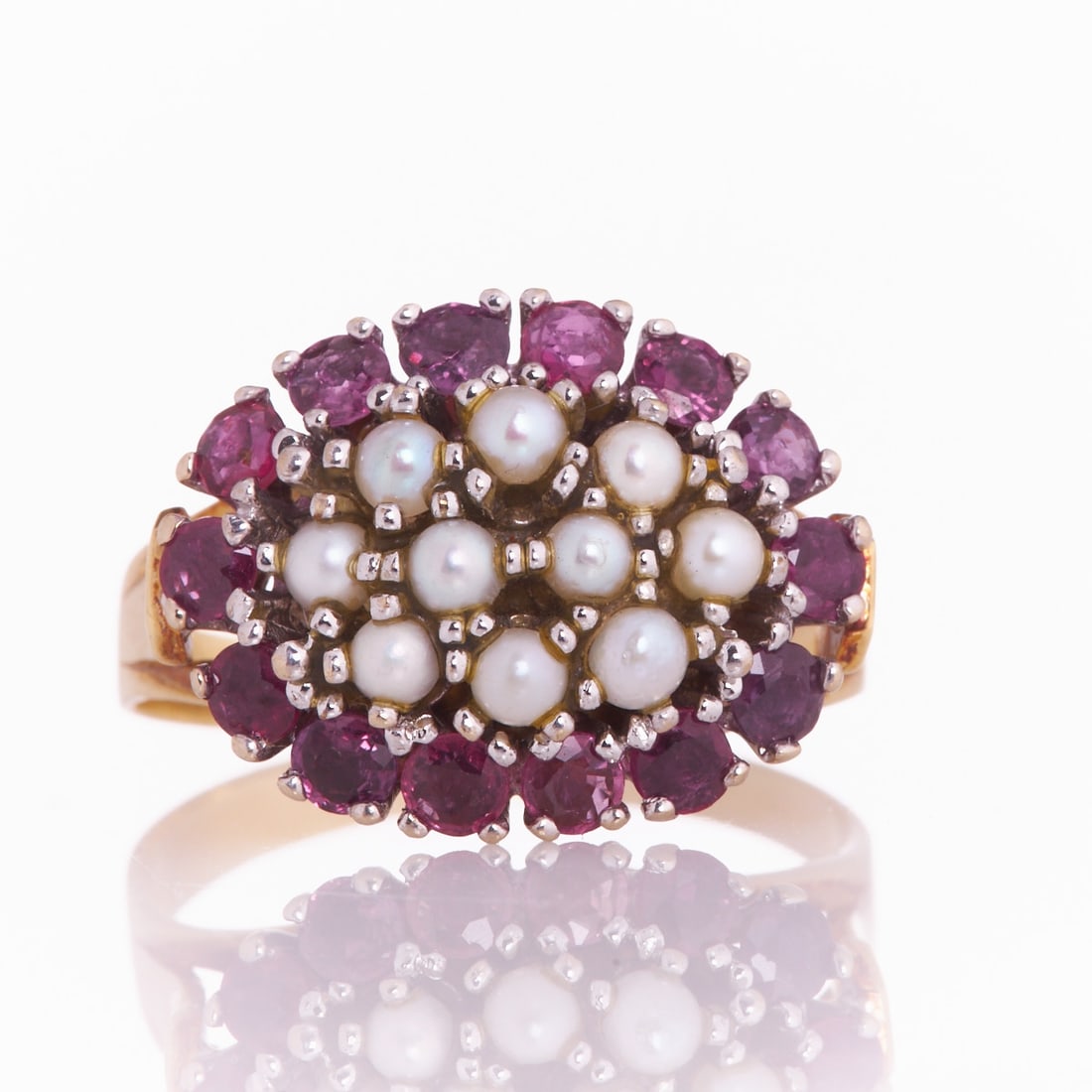 Pearl ring with rubies: Pearl ring with rubies 585/- yellow gold and white gold, stamped. Total weight: 6.1 g. 10 small pearls. 14 round cut rubies total approx. 1 ct. Ring size 57. Traces of wear. Decorative ring with pearl