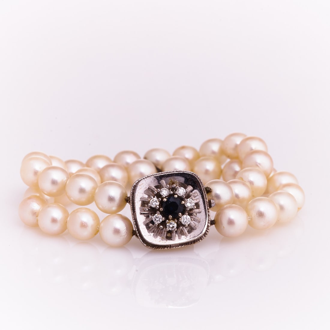 Two-row Pearl Bracelet with Diamond and Sapphire Clasp: Two-row Pearl Bracelet with Diamond and Sapphire Clasp 585/- white gold, stamped. Weight: 44.5 g. 36 cultured pearls (0.88 cm). 1 round-cut sapphire, approx. 0.85 ct. 7 brilliant-cut diamonds, totalin