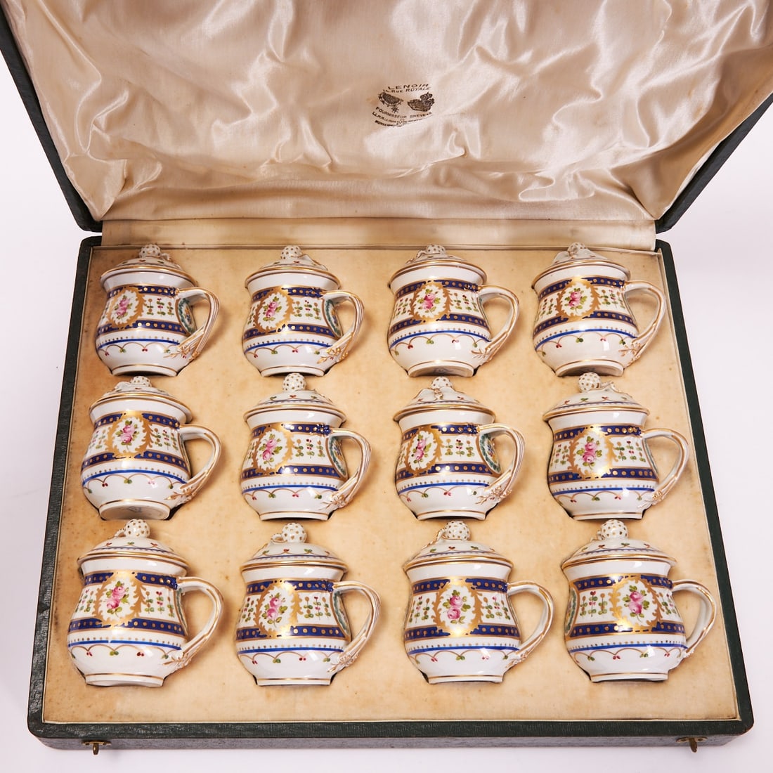 12 cream pots - flower painting in medallions, Paris or Potschappel, circa 1900: 12 cream pots - flower painting in medallions Paris or Saxon Porcelain Manufactory at Potschappel by Carl Thieme, Potschappel, circa 1900. Porcelain, white, glazed. Polychrome and gold painted. Gold r