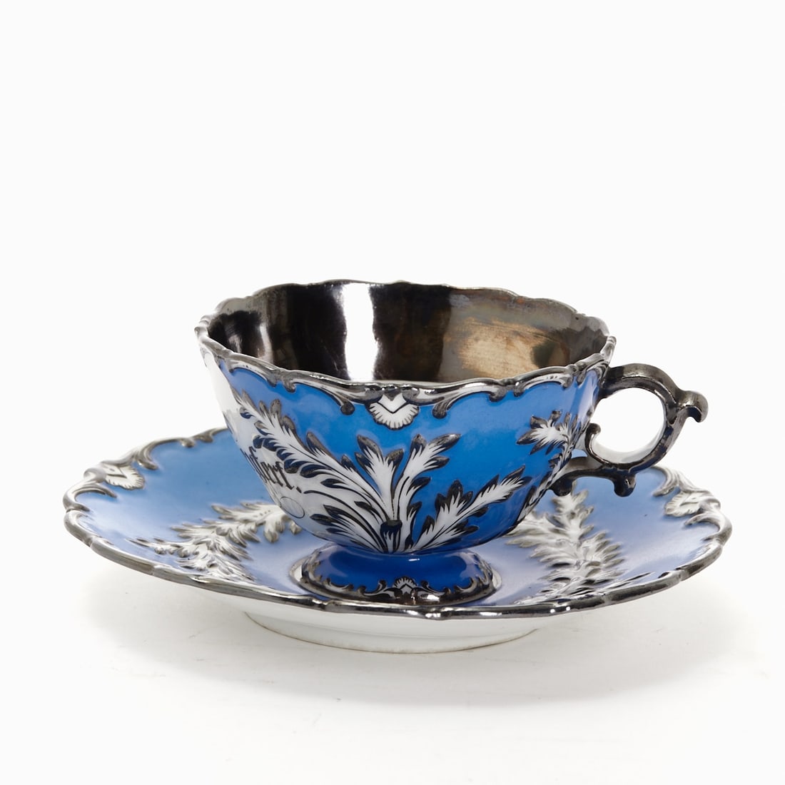 Commemorative cup with saucer - Charlotte Seyfert, Meissen c. 1858: Commemorative cup with saucer - Charlotte Seyfert Royal Porcelain Manufactory, Meissen c. 1858. Porcelain, white, glazed. Medium blue ground. Leaf relief with silver decoration. Blue sword mark underg
