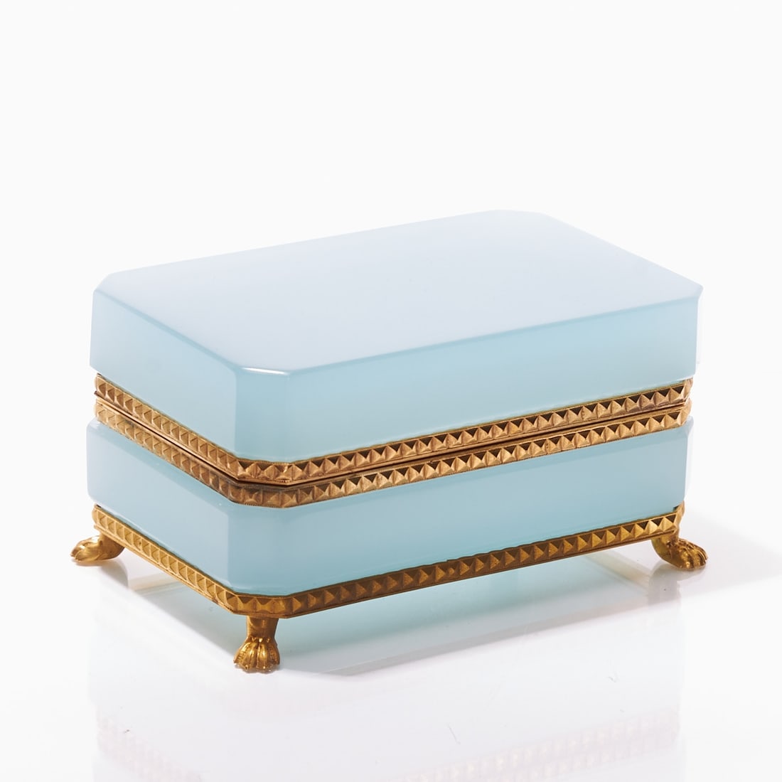 Octagonal lidded box on mounting with lion's feet - Art D?©co. France, circa 1935-1940.: Octagonal lidded box on mounting with lion's feet - Art Déco France, circa 1935-1940. Thick-walled, light blue opal glass, slightly translucent, cut and polished. Edges ground. Gilded brass mou