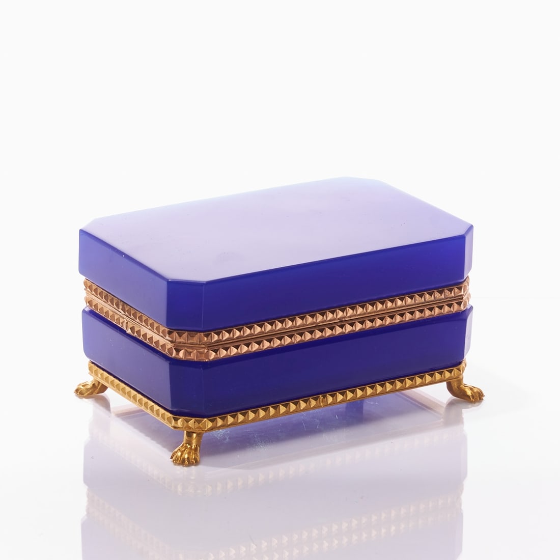 Octagonal lidded box on mounting with lion's feet - Art D?©co. France, circa 1935-1940.: Octagonal lidded box on mounting with lion's feet - Art Déco France, circa 1935-1940. Thick-walled, blue opal glass, slightly translucent, cut and polished. Edges ground. Gilded brass mounting 