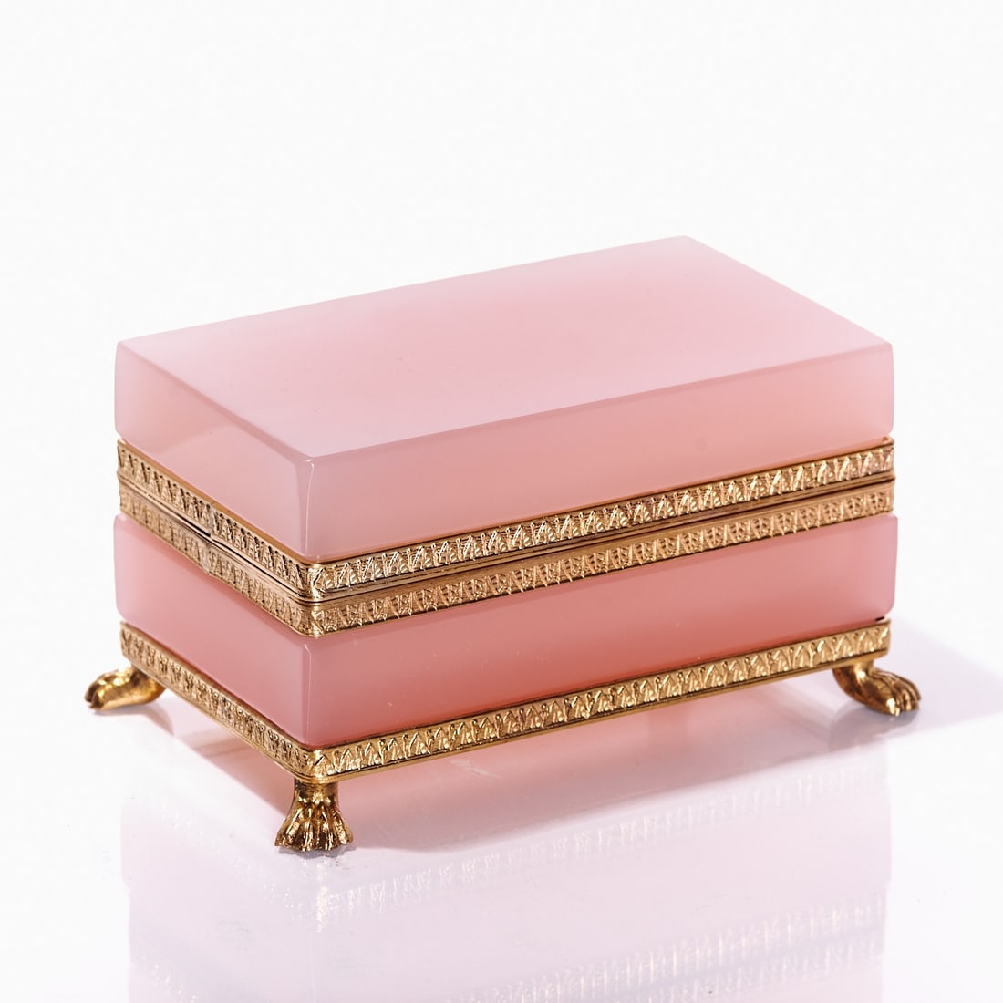 Rectangular lidded box on mounting with lion's feet - Art D?©co. France, circa 1935-1940.: Rectangular lidded box on mounting with lion's feet - Art Déco France, circa 1935-1940. Thick-walled, light pink opalescent glass, slightly translucent, cut and polished. Gilt brass mounting