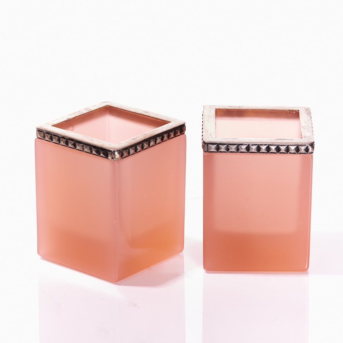 Pair of slightly conical pen holders - Art D?©co. France, circa 1935-1940.: Pair of slightly conical pen holders - Art Déco France, circa 1935-1940. Thick-walled, pink opalescent glass, slightly translucent, cut and polished. Silver-colored mounting with pyramid
