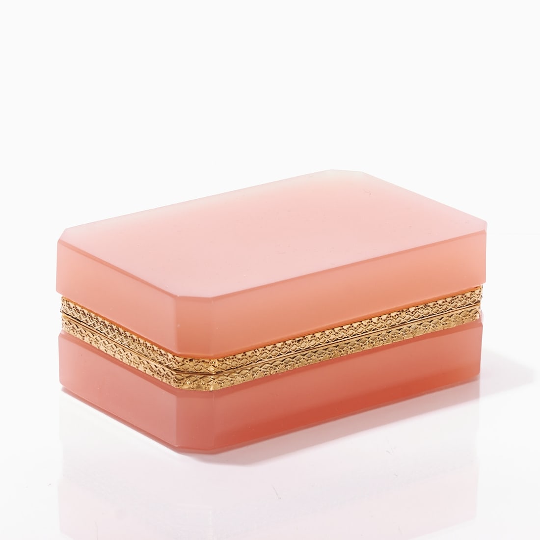 Octagonal lidded box - Art D?©co: France, circa 1935-1940.: Octagonal lidded box - Art Déco France, circa 1935-1940. Thick-walled, pink / salmon-colored opal glass, slightly translucent, cut and polished. Edges ground. Gilt, decorated brass mounting wit