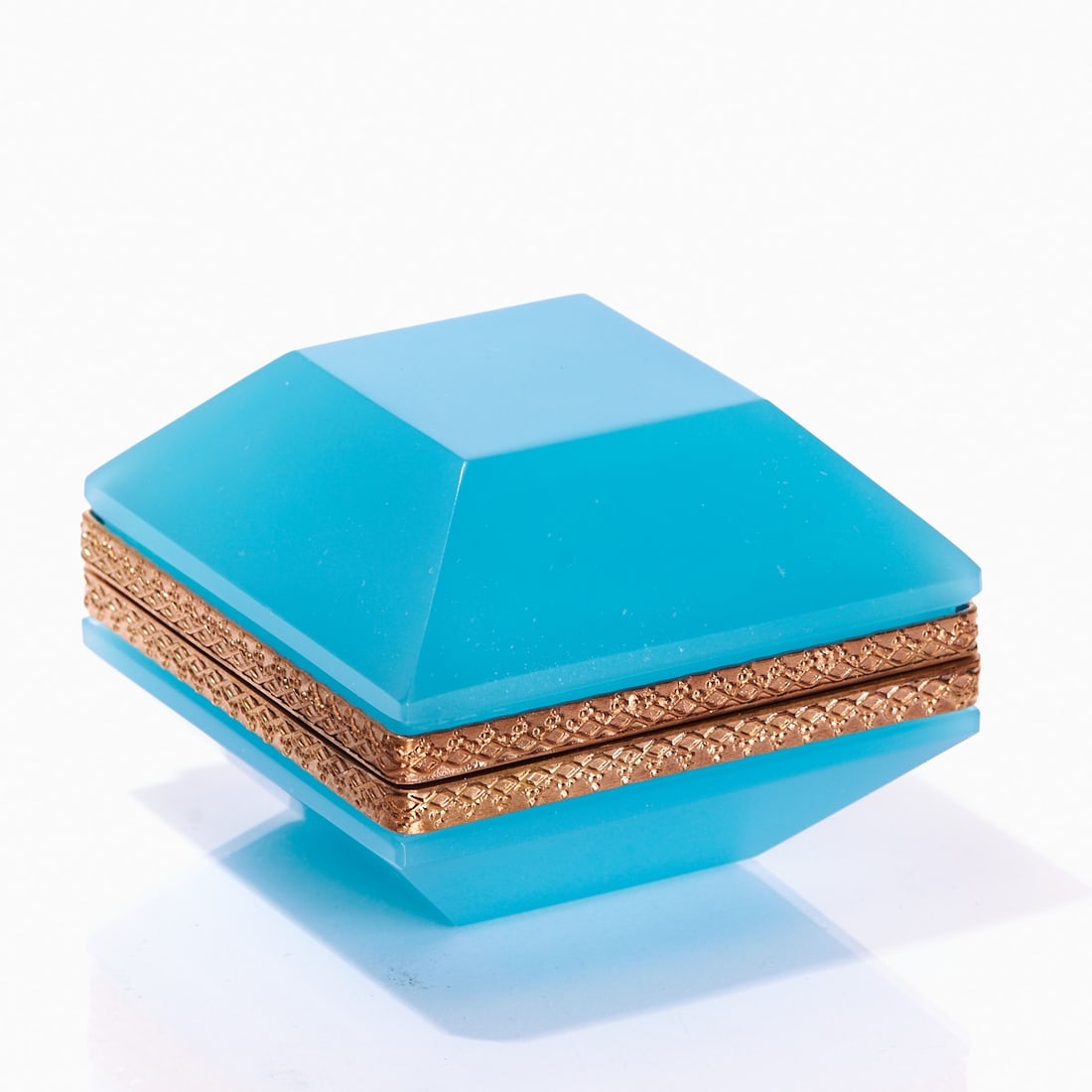 Trapezoidal lidded box - Art D?©co. France, circa 1935-1940.: Trapezoidal lidded box - Art Déco France, circa 1935-1940. Thick-walled, light blue opal glass, slightly translucent, cut and polished. Gilded brass mounting with hinge. Relief mounting. H. 6.5