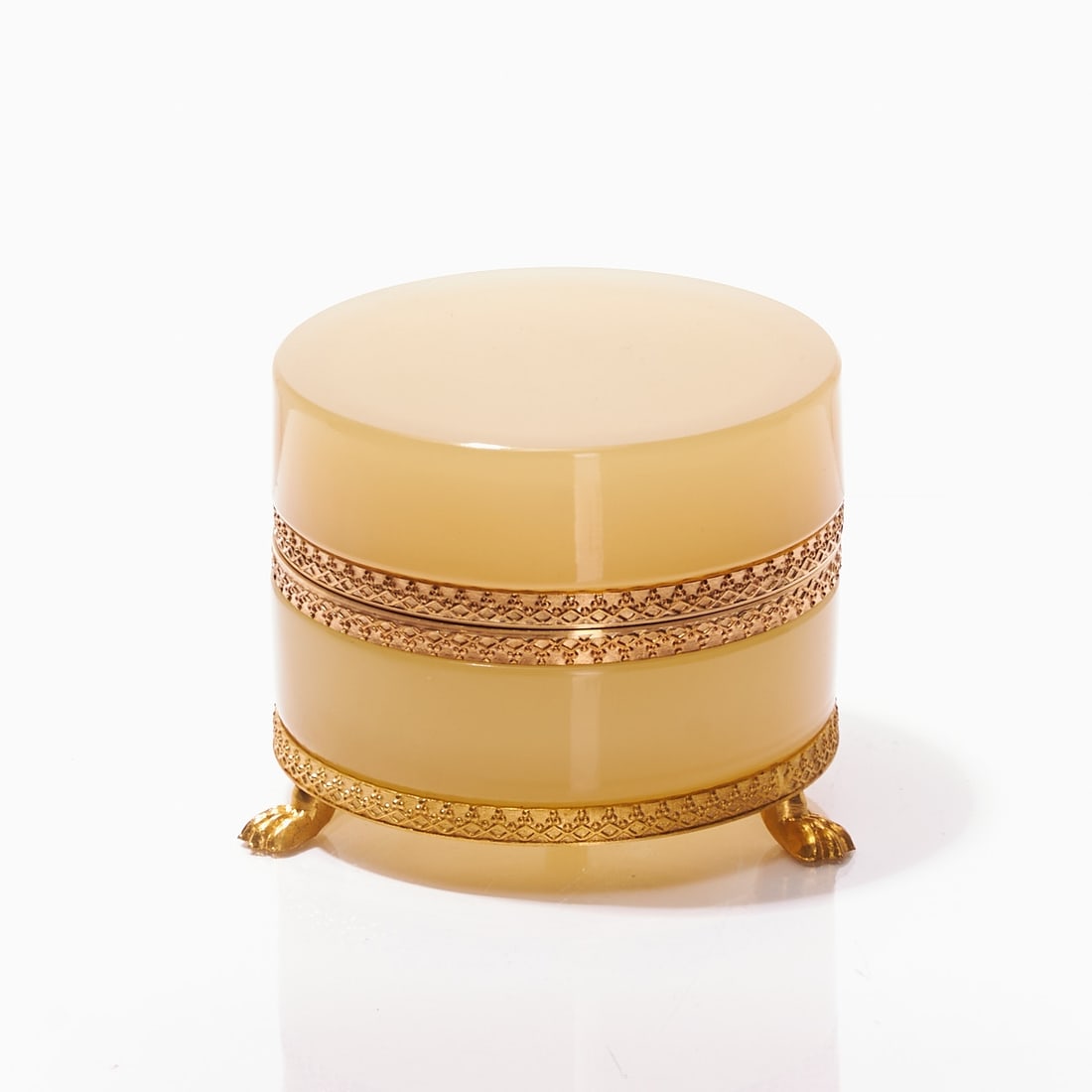 Round lidded box on mounting with lion's feet - Art Deco. France, circa 1935-1940.: Round lidded box on mounting with lion's feet - Art Deco France, circa 1935-1940. Uranium glass: Thick-walled, cream-colored opal glass (apple green), slightly translucent, cut and polished. Gilded, e