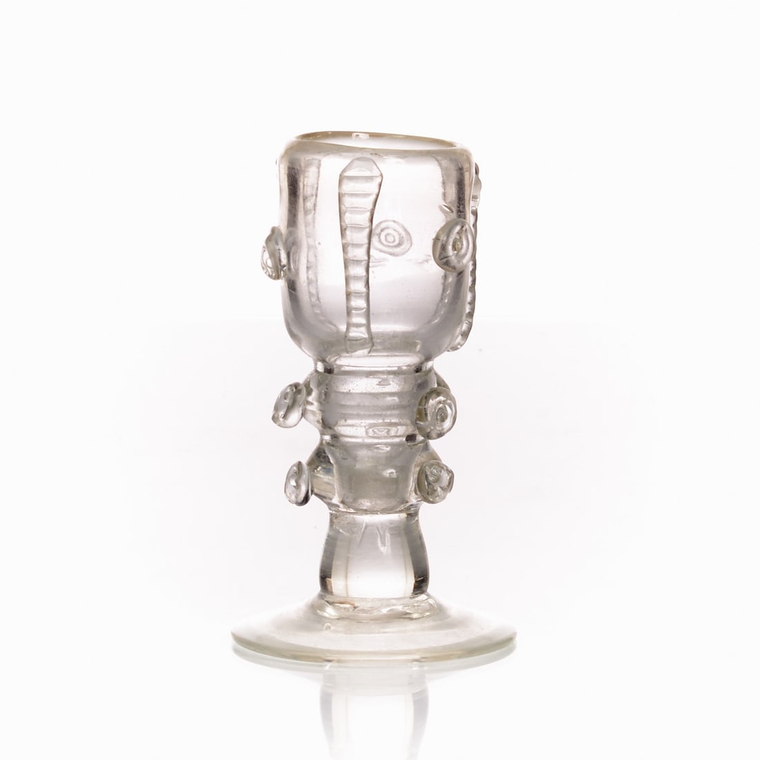 Footed glass / Stamper. 20th century.: Footed glass / Stamper 20th century. Colorless glass. Pontil mark. H. 13.5 cm. Round disc foot, stem with double knop, bowl and stem with fused glass prunts and glass bands. Bowl without base transiti