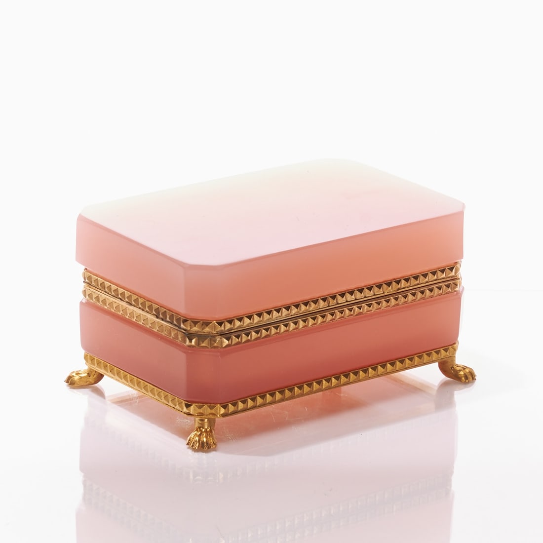 Octagonal covered box on mounting with lion's feet - Art D?©co. France, circa 1935-1940.: Octagonal covered box on mounting with lion's feet - Art Déco France, circa 1935-1940. Thick-walled, light pink opaline glass, slightly translucent, cut and polished. Edges cut. Gilded brass mo