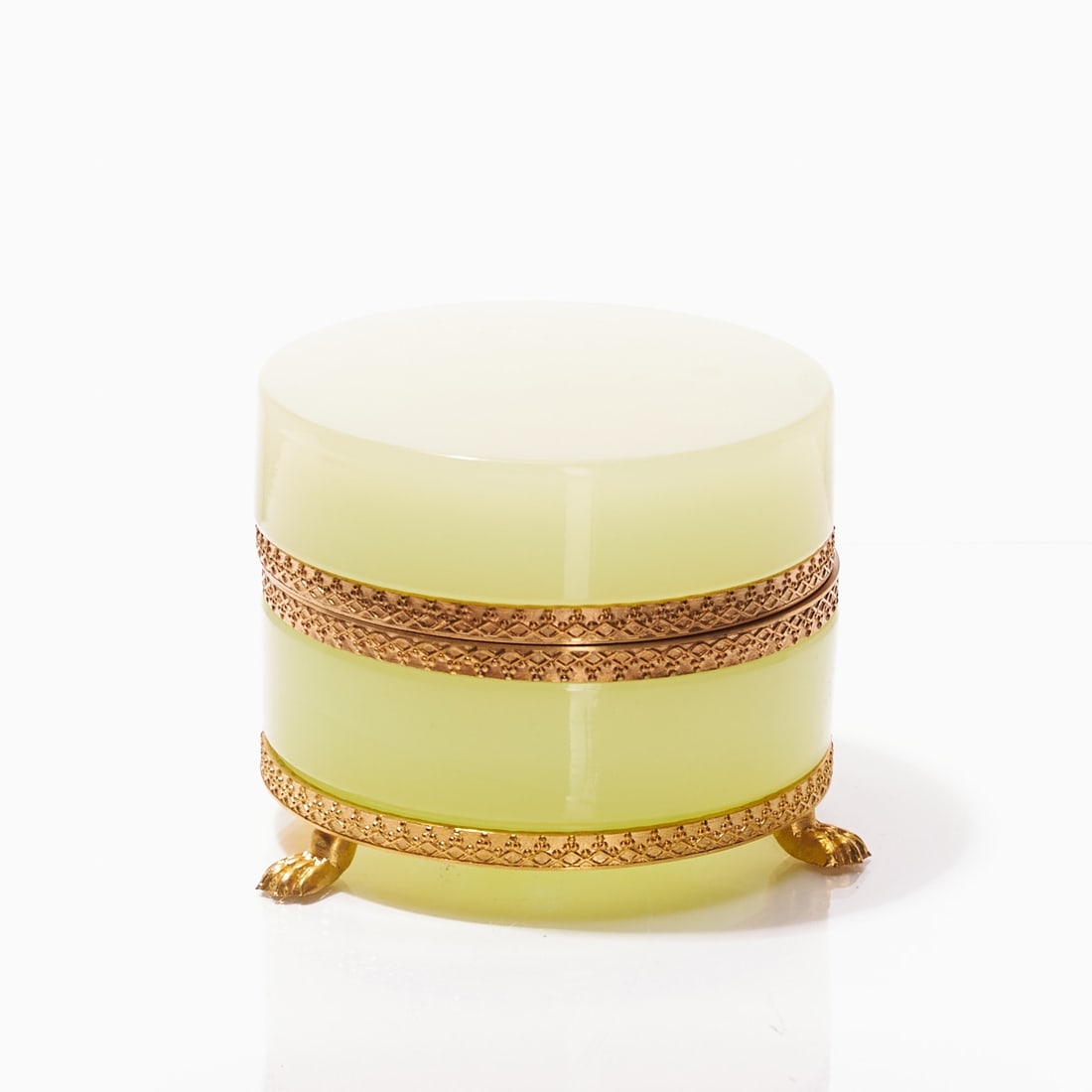 Round covered box on mounting with lion's feet - Art D?©co. France, circa 1935-1940.: Round covered box on mounting with lion's feet - Art Déco France, circa 1935-1940. Uranium glass: Thick-walled, light green opaline glass (apple green), slightly translucent, cut and polished. 