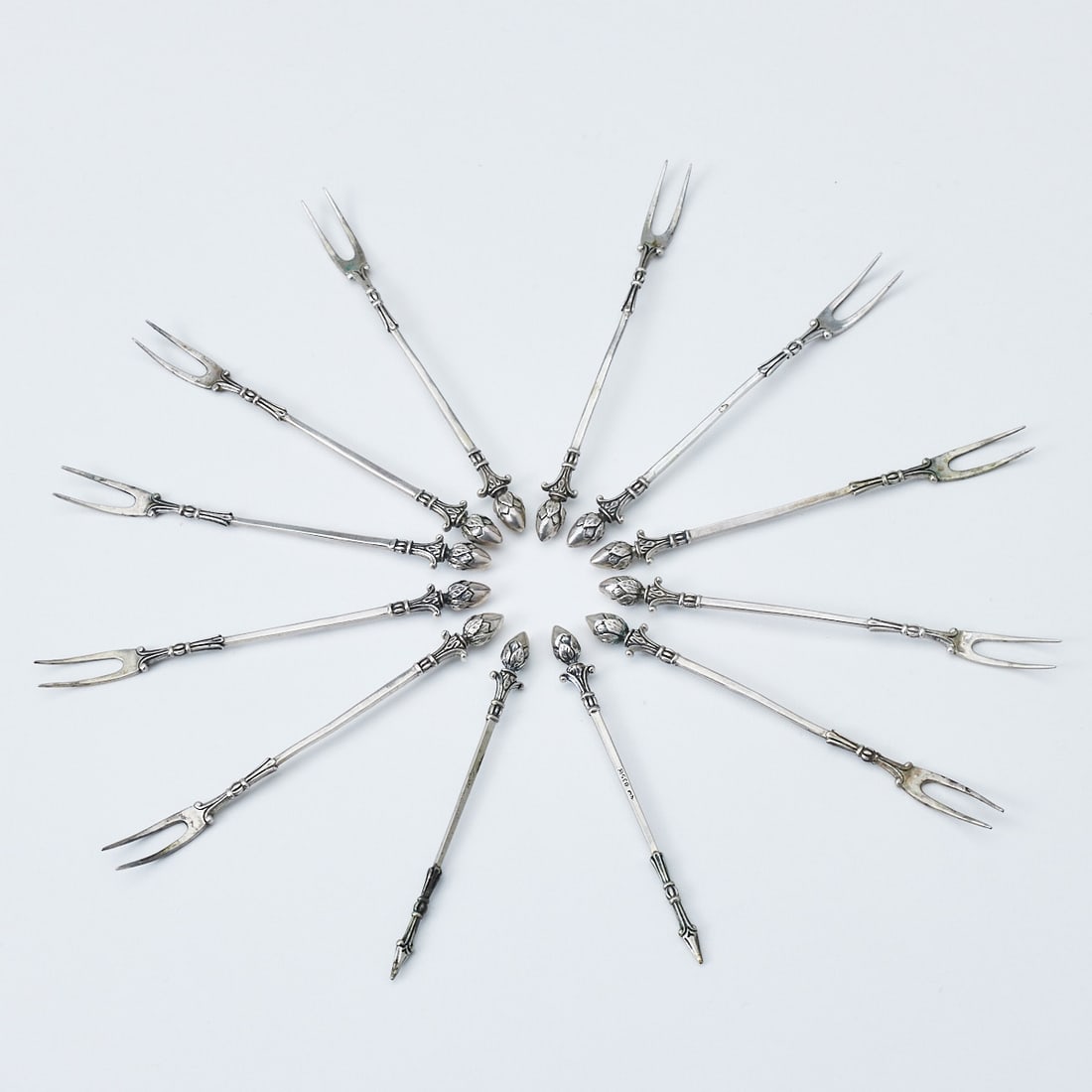 10 meat forks & 2 picks: 10 meat forks & 2 picks Christoph Widmann/Pforzheim. 835 silver. Hallmarks: maker's mark, 835, crescent/crown. L. 9.5 cm. Weight: 54 g.