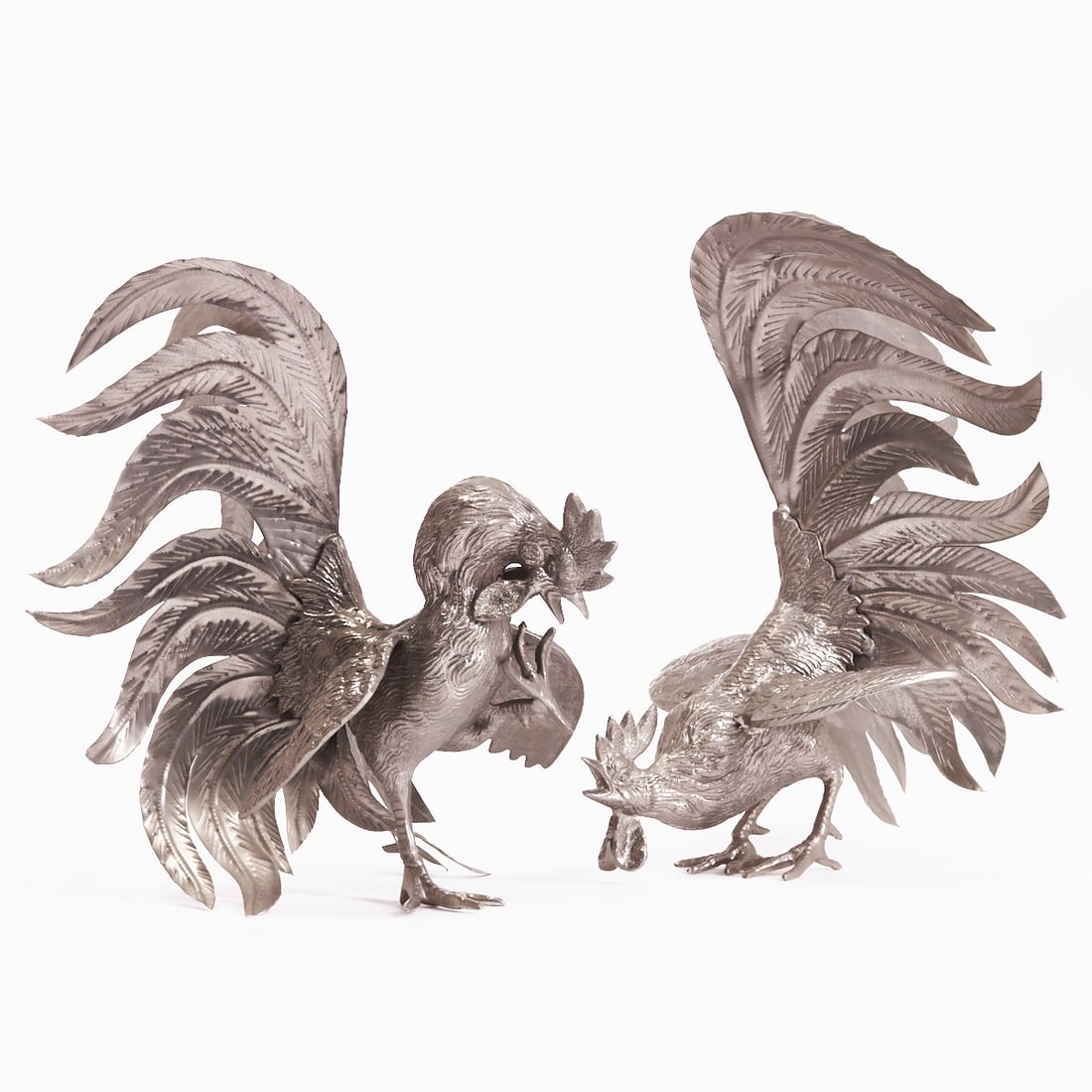 Pair of Decorative Rooster Sculptures: Pair of Decorative Rooster Sculptures Probably Italy, 20th century. Metal, silver-plated. H. 31 cm. Two fully sculpted roosters in dynamic poses. Naturalistically modeled plumage. Finely chased
