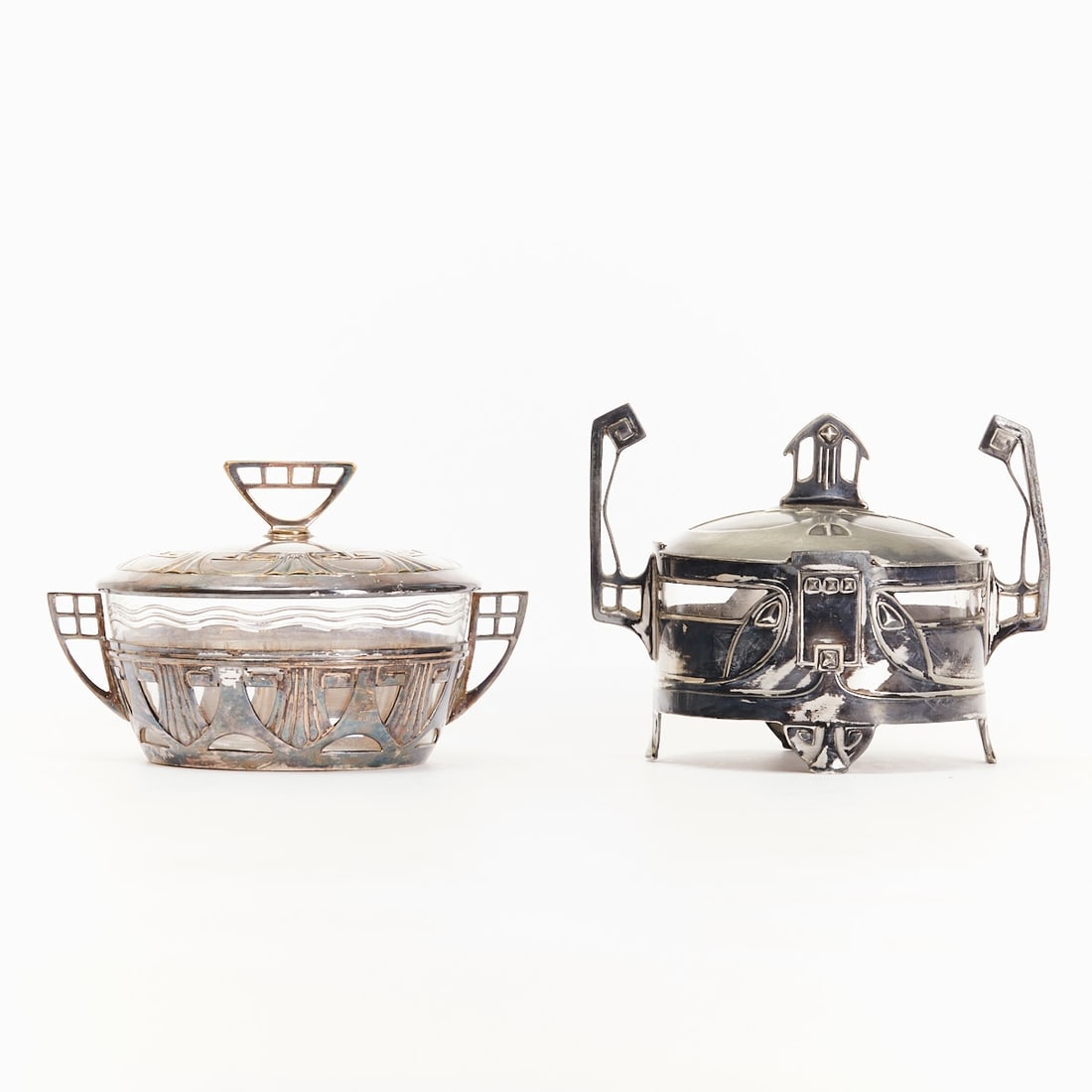 Pair of Art Nouveau sugar bowls: Pair of Art Nouveau sugar bowls with glass insert Germany/Austria, circa 1900. Each silver-plated metal, colorless glass insert. Round body, curved side handles, lid with stirrup handle. One box with 