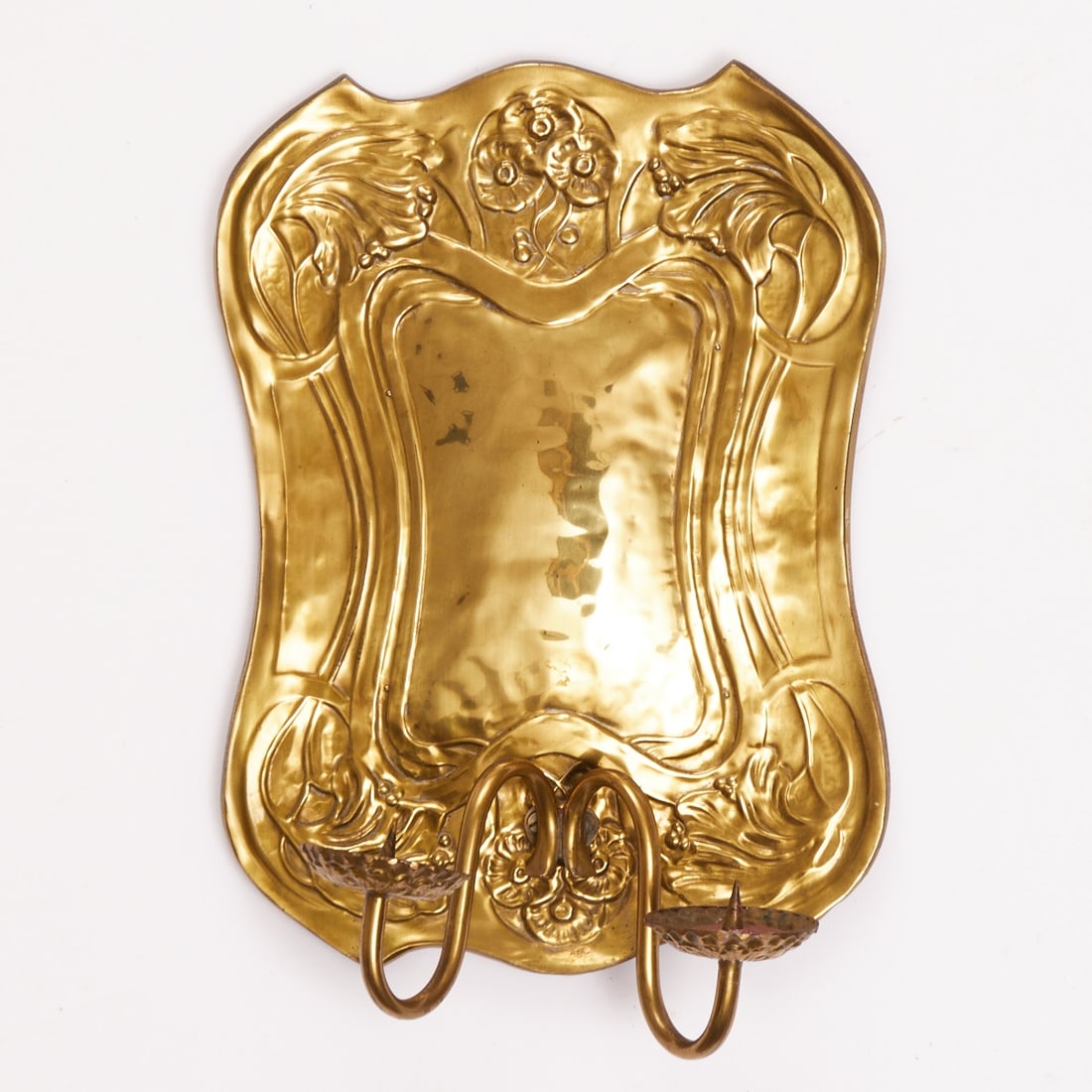 Art Nouveau wall console / sconce: Art Nouveau wall console / sconce Germany, circa 1900/1910. Brass, with wooden plate on the reverse. Rectangular, curved shape with floral Art Nouveau relief and a central, smooth cartouche. Two curve