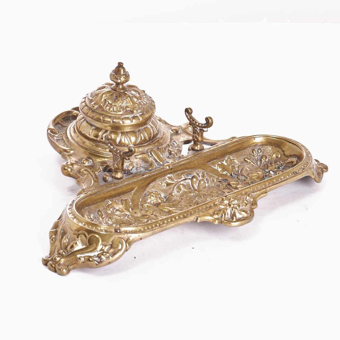 Historicism Writing Set: Historicism writing set France, 19th century. Bronze, W. 29 cm, D. 22 cm, H. 10 cm. Oval, ornamentally reliefed body with a central depiction of a putto with a dragonfly, flanked by floral decor.