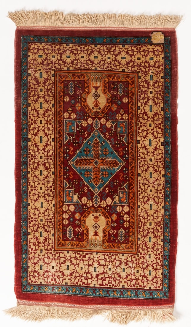 Ghom: Ghom Central Persia, mid-20th century. Pure silk on silk. Small area and collector's rug. Approx. 73 x 39 cm. Signature. The finely proportioned inner field features a stylized prayer niche with a cen
