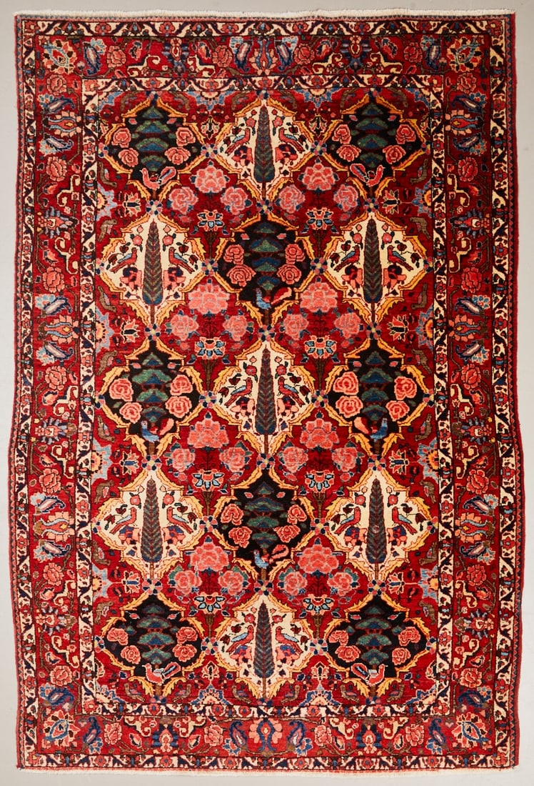 Bakhtiari Rug: Bakhtiari rug Persia, circa 1900. Wool on cotton, approx. 210 × 139 cm. Hand-knotted rug with dense, symmetrical floral decoration on a light background. Recurring floral and palmette motifs in