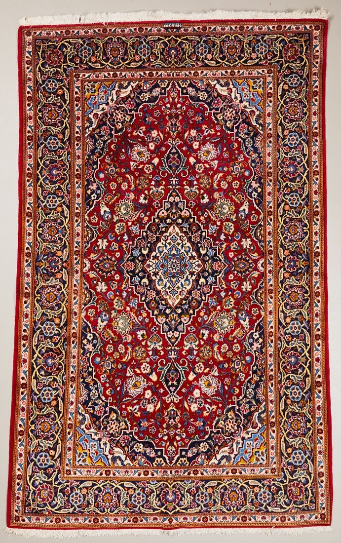 Kashan Carpet: Kashan Carpet, Persia/Orient, 20th century. Wool on cotton, approx. 226 x 133 cm. Signature. Hand-knotted carpet with a red central field and a central, star-shaped medallion in shades of cream, blue,