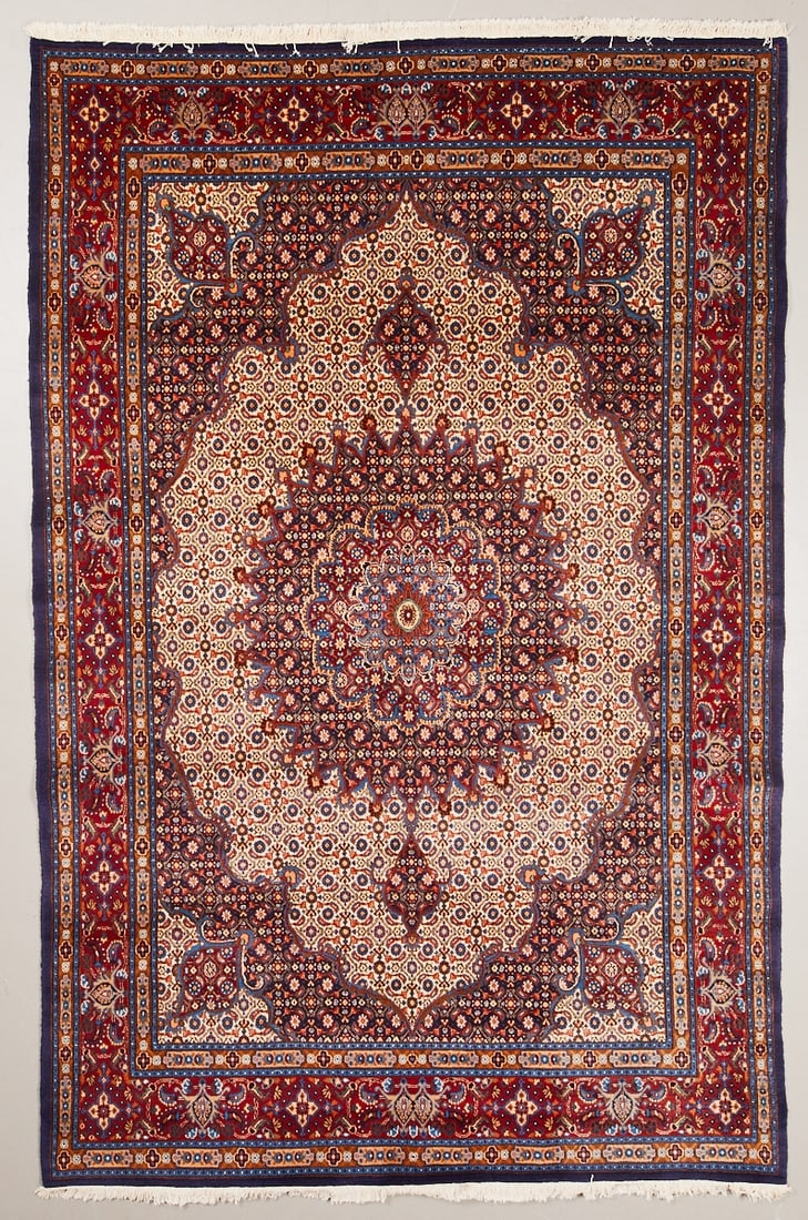 Moud Carpet: Moud Carpet, Persia, 20th century. Wool on cotton, approx. 307 x 203 cm. Hand-knotted carpet with a light, densely patterned central field and a large central floral medallion in shades of blue, red,