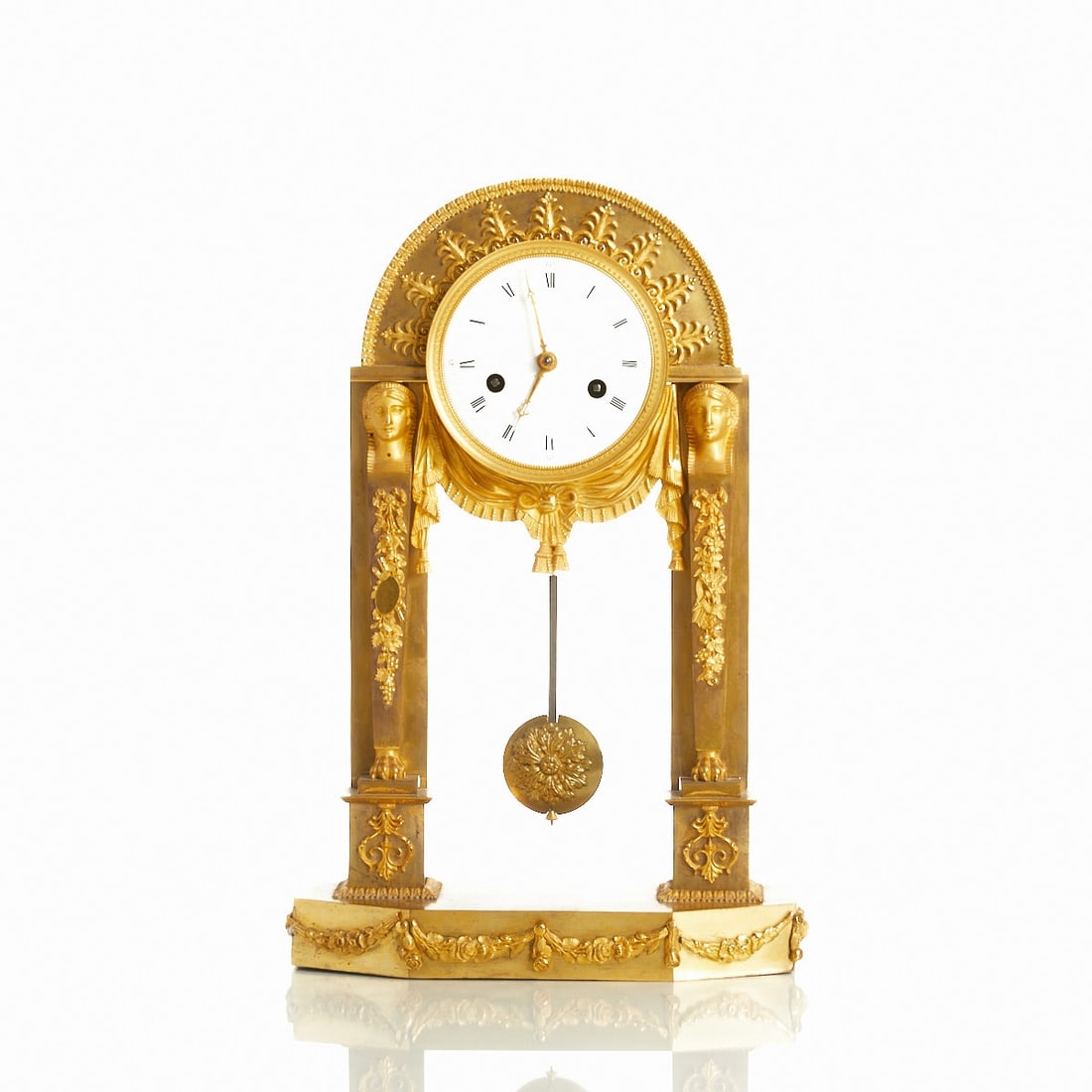 Empire Pendulum Clock: Empire Pendulum Clock France, circa 1810. Bronze/gilt. H. 41 cm. Striking on bell. Thread suspension. Roman and Arabic numerals. Pendulum. Movement and function without guarantee.