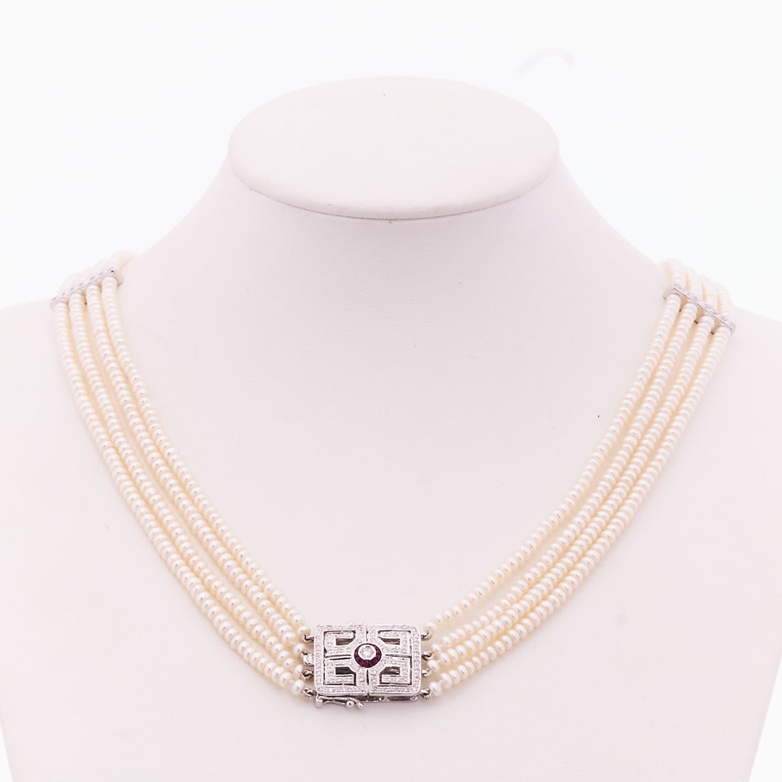 Pearl necklace with white gold clasp - four-row: Pearl necklace with white gold clasp - four-row 750/- white gold, stamped. Weight: 30.6 g. Various diamonds and various rubies. Various pearls (D. 0.29 cm). L. 41 cm. Box clasp. Very good condition.