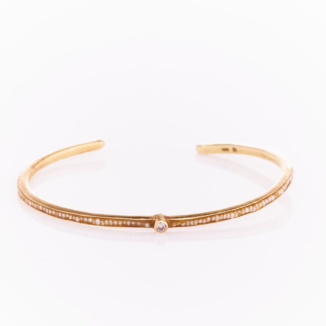 Antique Bangle with Inlaid Pearls and Brilliant: Antique bangle with inlaid pearls and brilliant Circa 1900. 585/- yellow gold, stamped. Weight: 7 g. Various pearls. 1 old-cut diamond approx. 0.05 ct. Inner dimensions: 4.5 x 5.5 cm. Signs of wear,