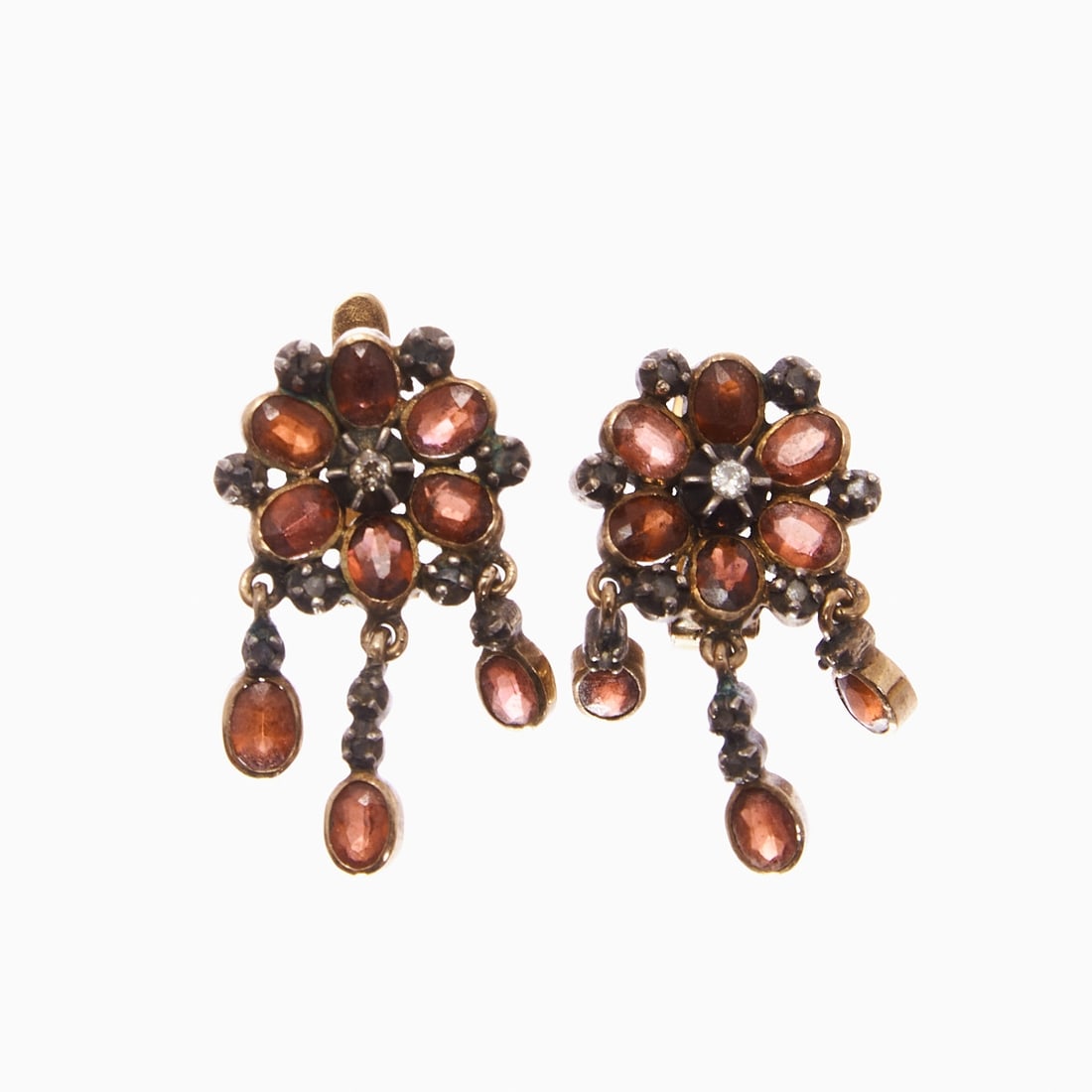 Pair of historical garnet earrings Circa 1900.: Pair of historical garnet earrings Circa 1900. 750/- yellow gold, unmarked, tested, partially silver, tested. Total weight: 7.9 g. Numerous faceted garnets in different cuts. Small diamond setting.