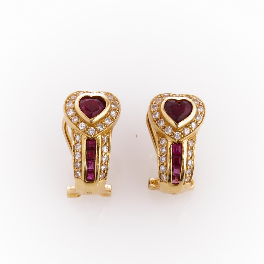 Pair of heart-shaped ruby earrings: Pair of heart-shaped ruby earrings 750/- yellow gold, stamped. Weight: 7.2 g. Hallmarks: 750, HPE. 2 heart-cut rubies, 8 baguette-cut rubies 1.45 ct. Various brilliant-cut diamonds totaling approx.