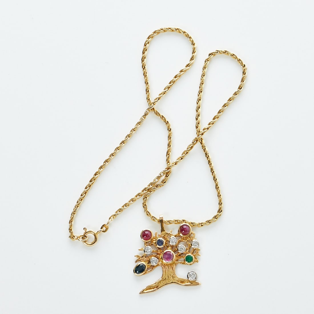 Tree of Life Pendant or Fruit Tree: Tree of Life Pendant or Fruit Tree 585/- yellow gold, hallmarked. Weight: 16.2 g. 2 sapphires in round and oval cut totaling approx. 0.4 ct. 3 rubies in cabochon and round cut totaling approx. 1 ct.